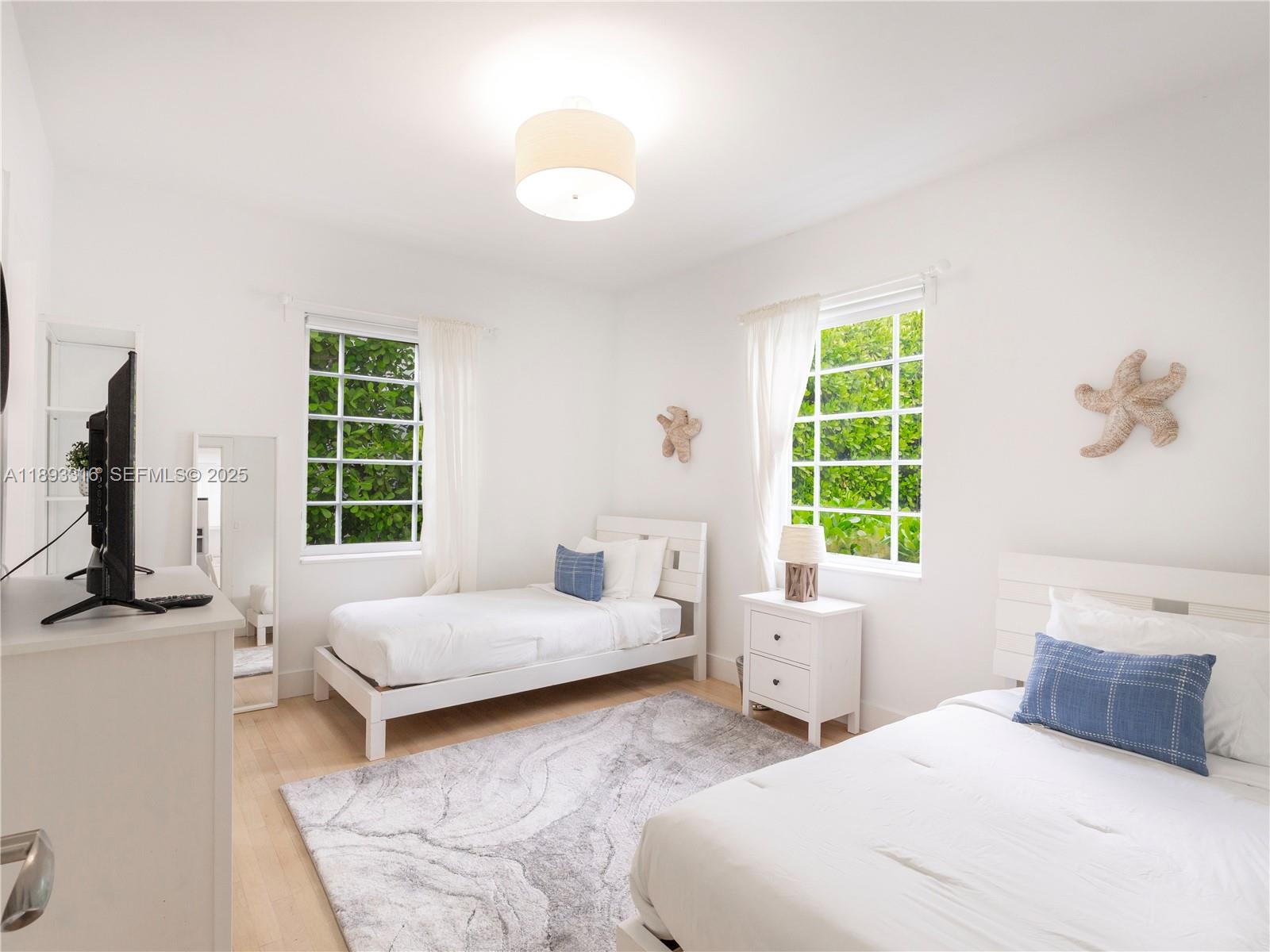 241 28th Street, Unit 1 Miami Beach, FL 33140 - Photo 10 of 16 a bedroom with a bed and a window