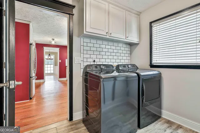 a utility room with sink dryer and washer