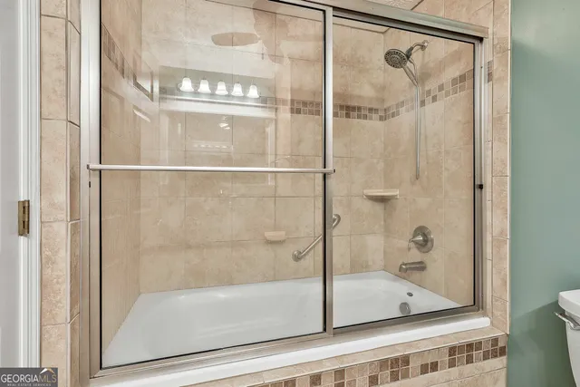 a bathroom with a glass shower door
