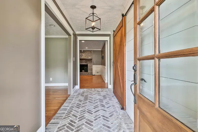 a view of hallway with wooden floor and staircase