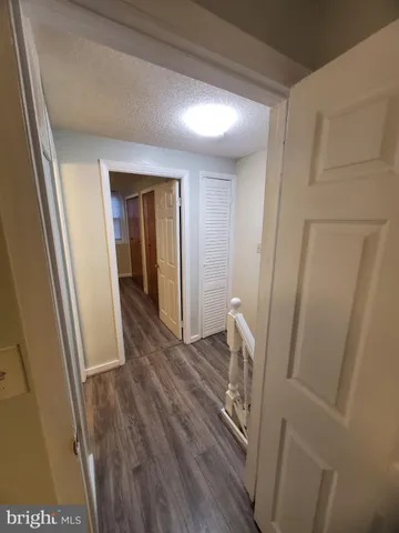 a view of an empty room and wooden floor