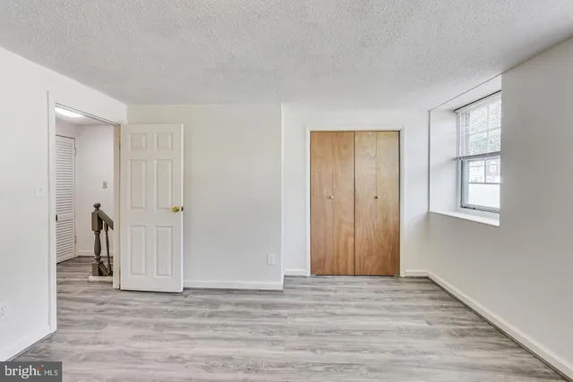 a view of wooden floor and windows in a room