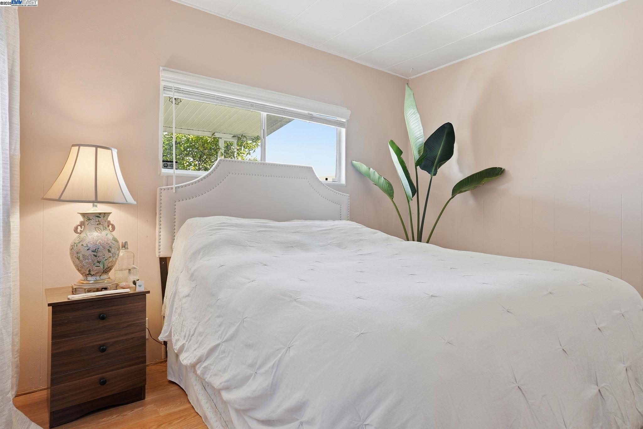 4141 Deep Creek Road, Unit 89 Fremont, CA 94555 - Photo 25 of 54 a bedroom with a bed and a lamp on dresser