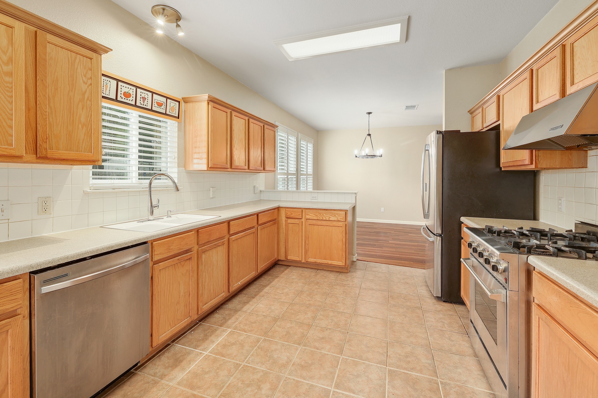 4615 Tello Path Austin, TX 78749 - Photo 11 of 31 Ample wooden cabinetry and ceramic tile flooring define this functional kitchen space.