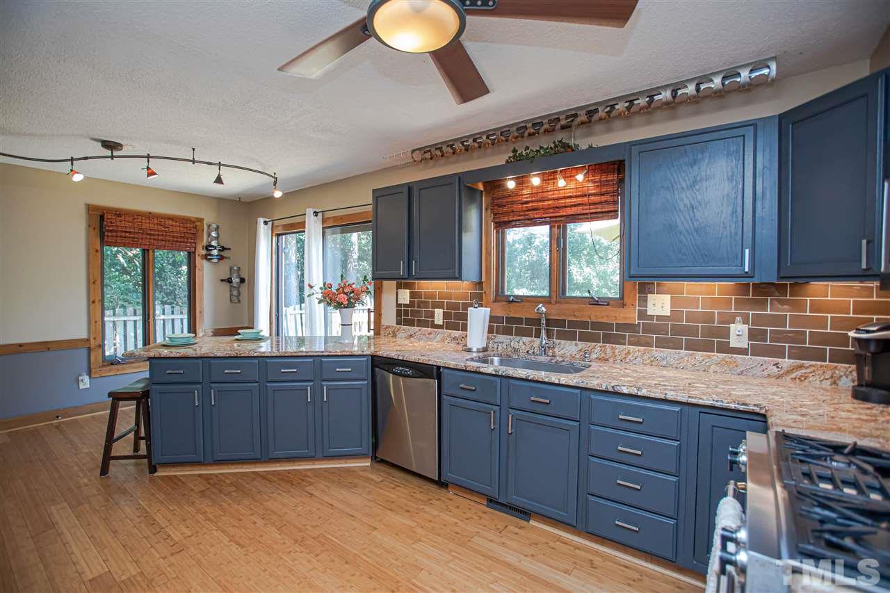 2521 Scouting Trail Raleigh, NC 27615 - Photo 13 of 29 a kitchen with granite countertop sink cabinets and window