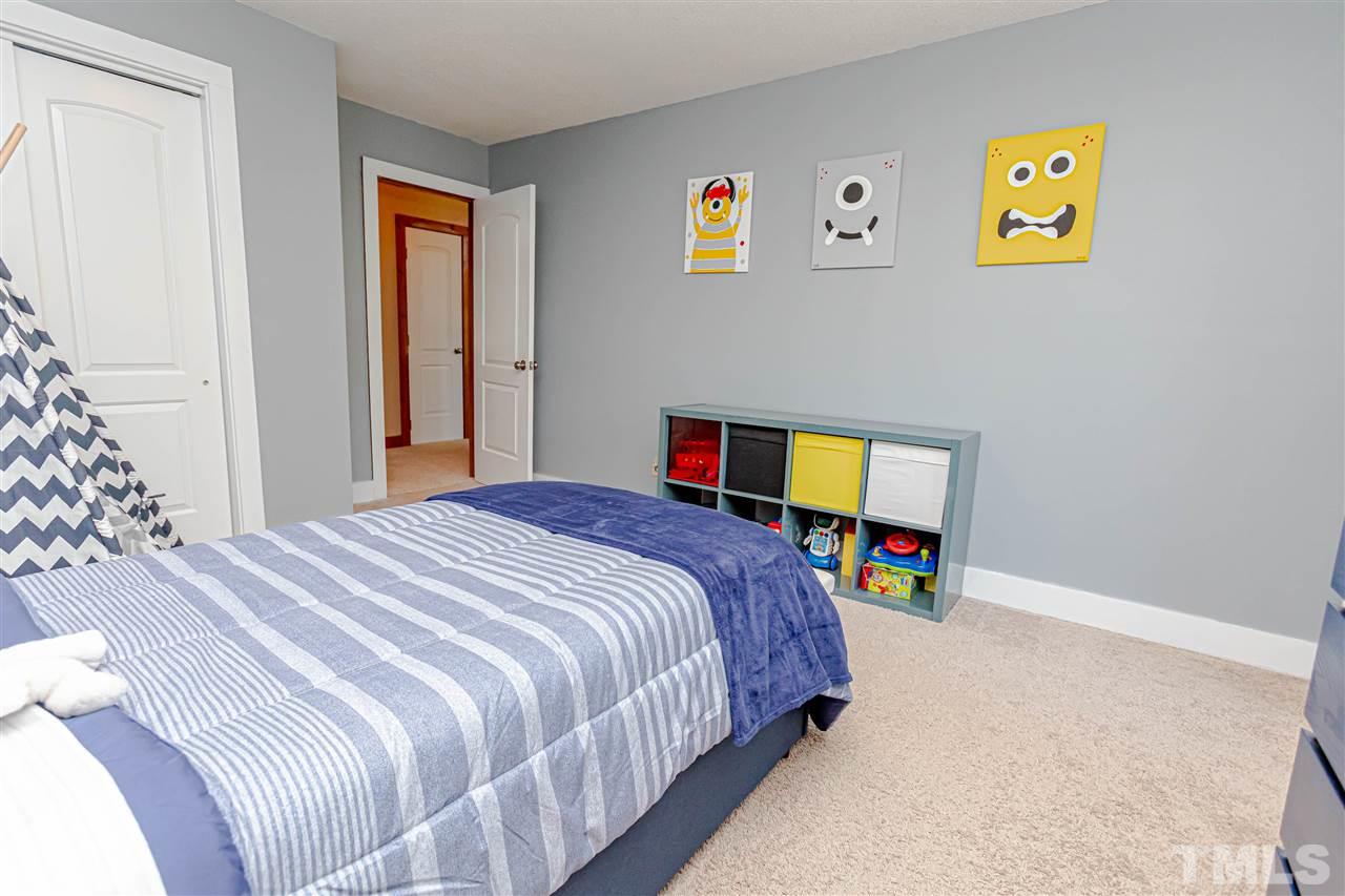 2521 Scouting Trail Raleigh, NC 27615 - Photo 16 of 29 a bedroom that has a bed and a desk in it