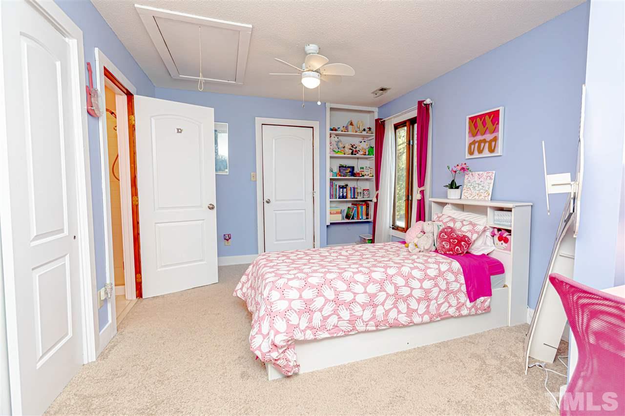 2521 Scouting Trail Raleigh, NC 27615 - Photo 18 of 29 a bedroom with a bed and a dresser