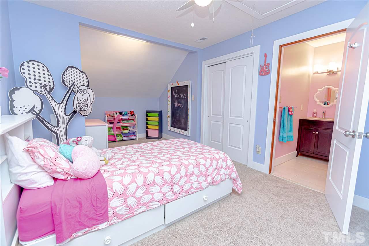 2521 Scouting Trail Raleigh, NC 27615 - Photo 20 of 29 a bedroom with a bed and a dresser