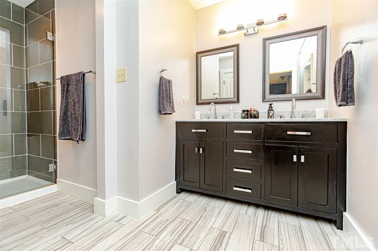 2521 Scouting Trail Raleigh, NC 27615 - Photo 24 of 29 a bathroom with a double vanity sink and mirror