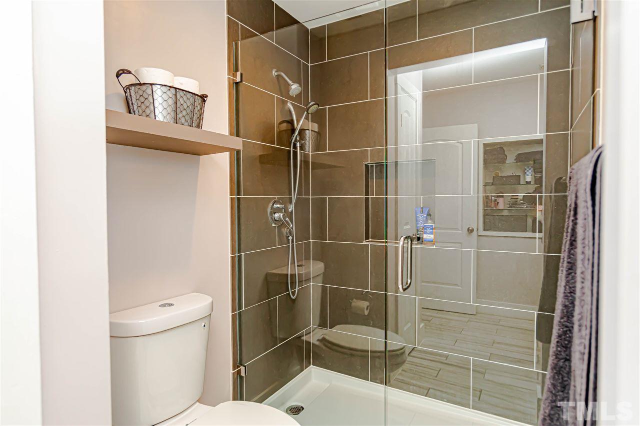 2521 Scouting Trail Raleigh, NC 27615 - Photo 25 of 29 a bathroom with a toilet and a shower