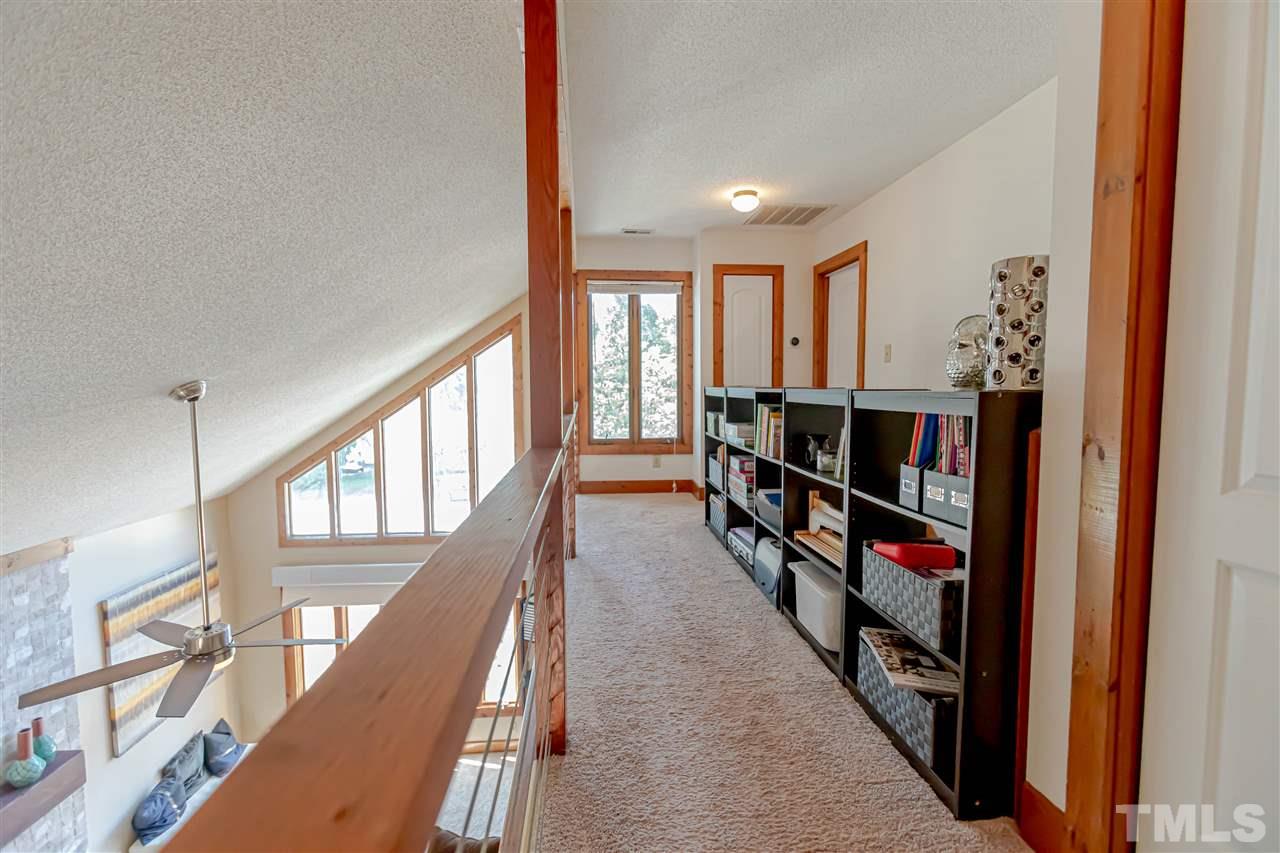 2521 Scouting Trail Raleigh, NC 27615 - Photo 26 of 29 a view of a hallway with wooden floor and windows