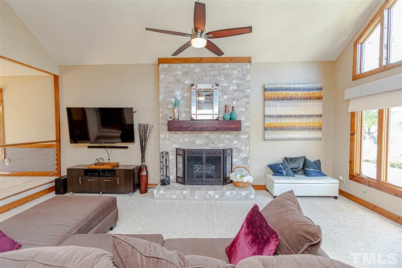 2521 Scouting Trail Raleigh, NC 27615 - Photo 4 of 29 a living room with furniture a flat screen tv and a fireplace