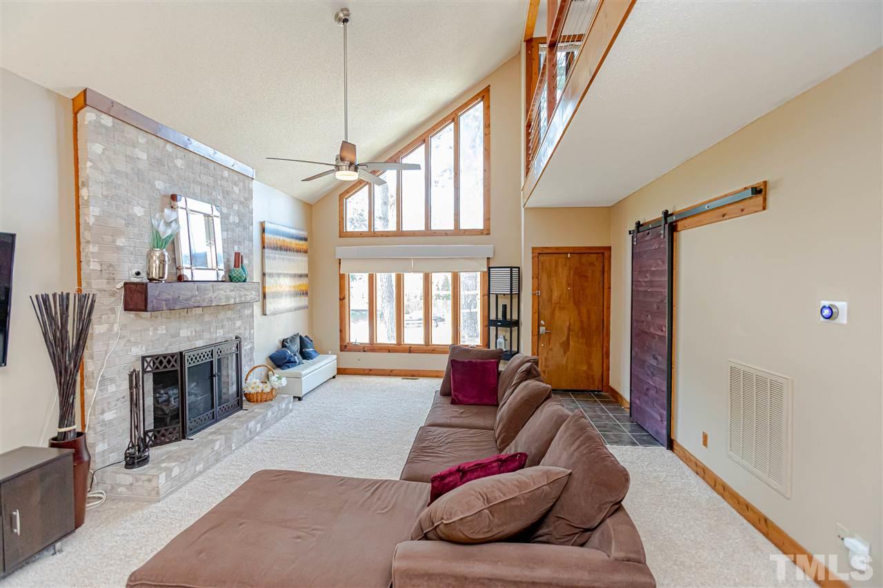 2521 Scouting Trail Raleigh, NC 27615 - Photo 6 of 29 a living room with furniture window and a fireplace