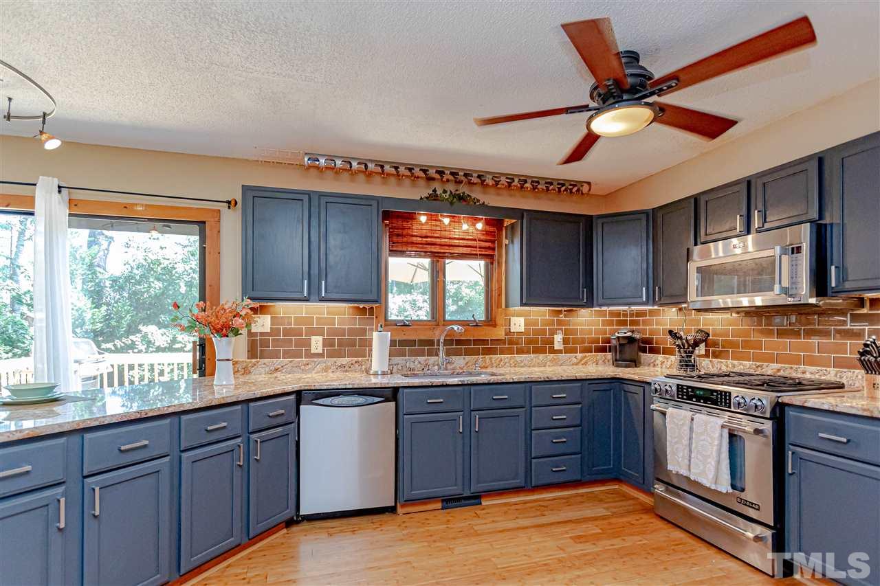 2521 Scouting Trail Raleigh, NC 27615 - Photo 10 of 29 a kitchen with stainless steel appliances granite countertop wooden cabinets sink and window