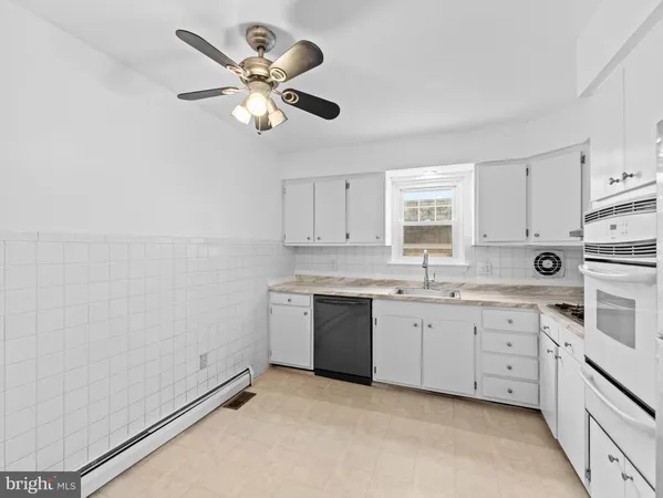 a kitchen with a sink cabinets and window