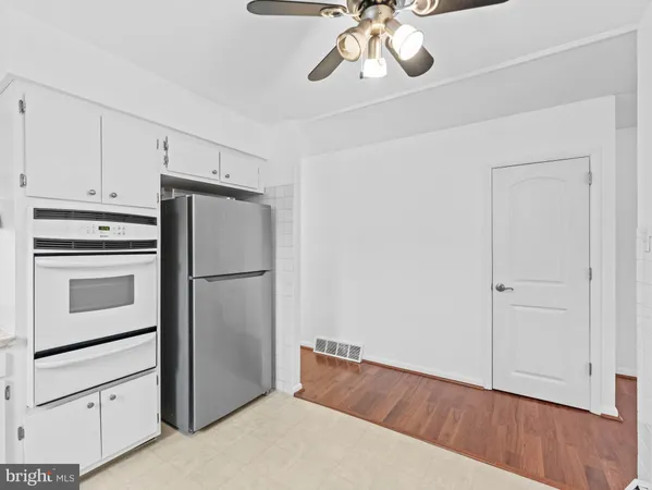 a kitchen with cabinets and stainless steel appliances