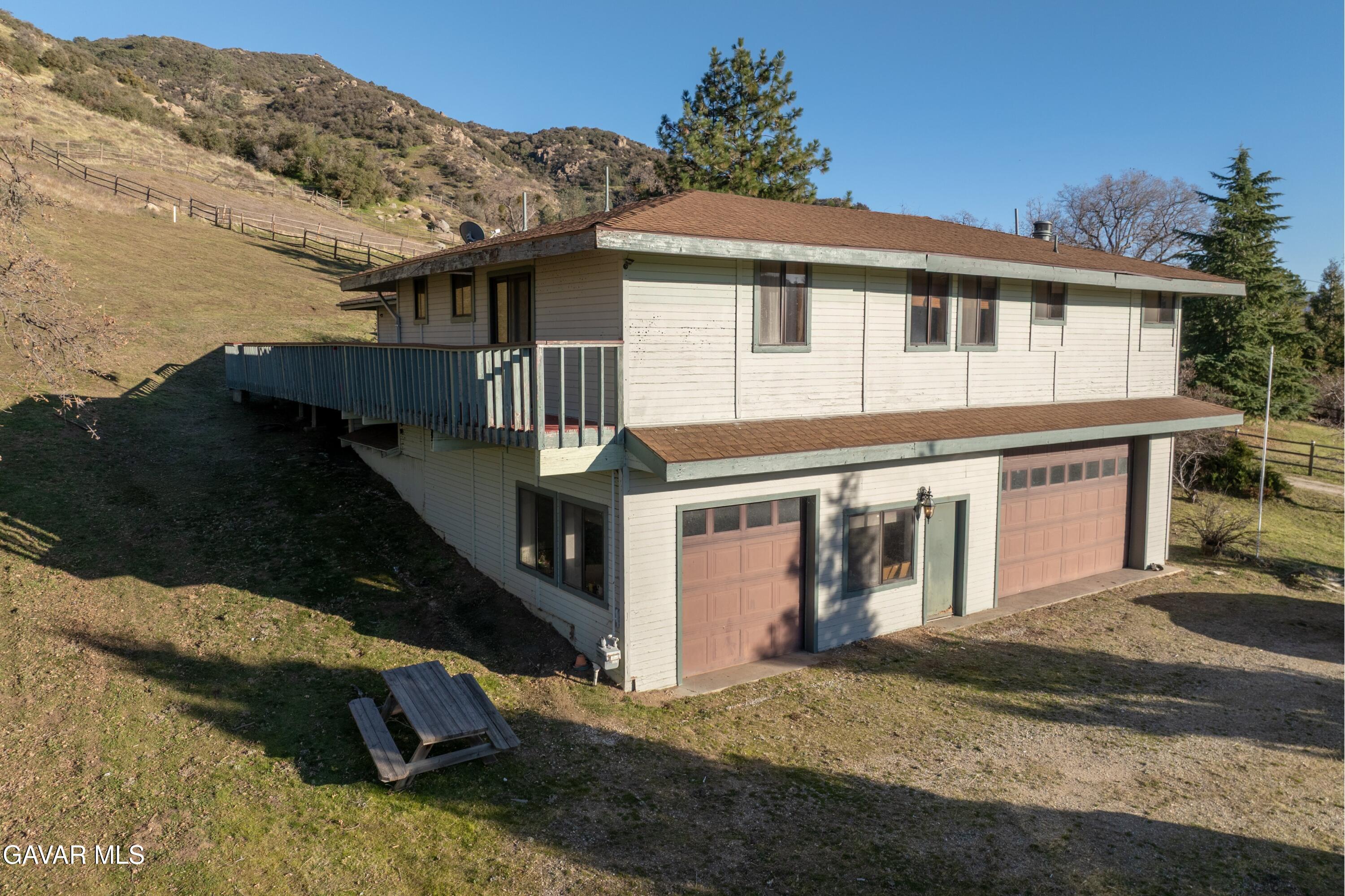 26181 Bear Valley Road Tehachapi, CA 93561 - Photo 12 of 38 a front view of a house with a yard
