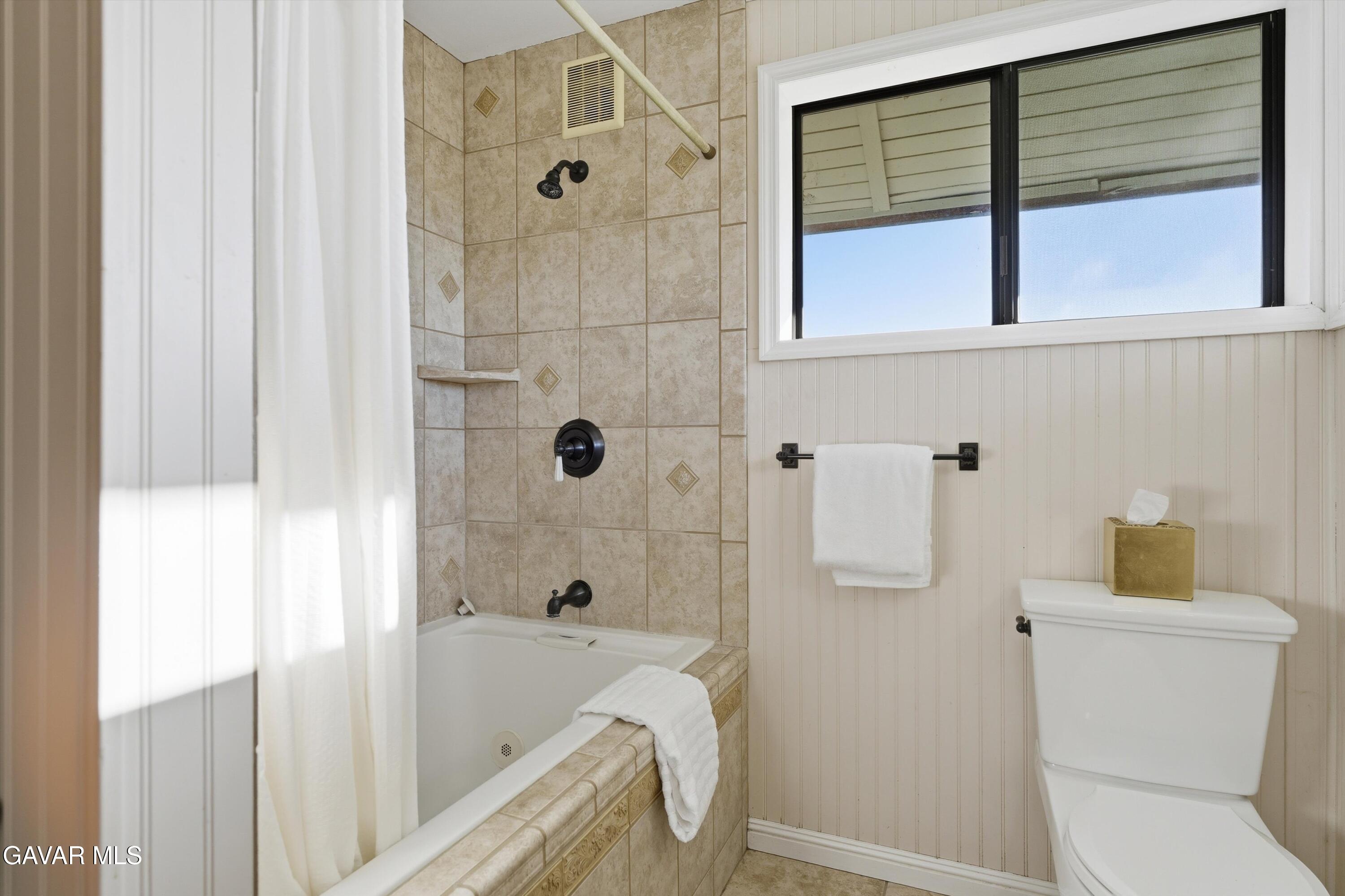 26181 Bear Valley Road Tehachapi, CA 93561 - Photo 14 of 38 a bathroom with a sink and a shower