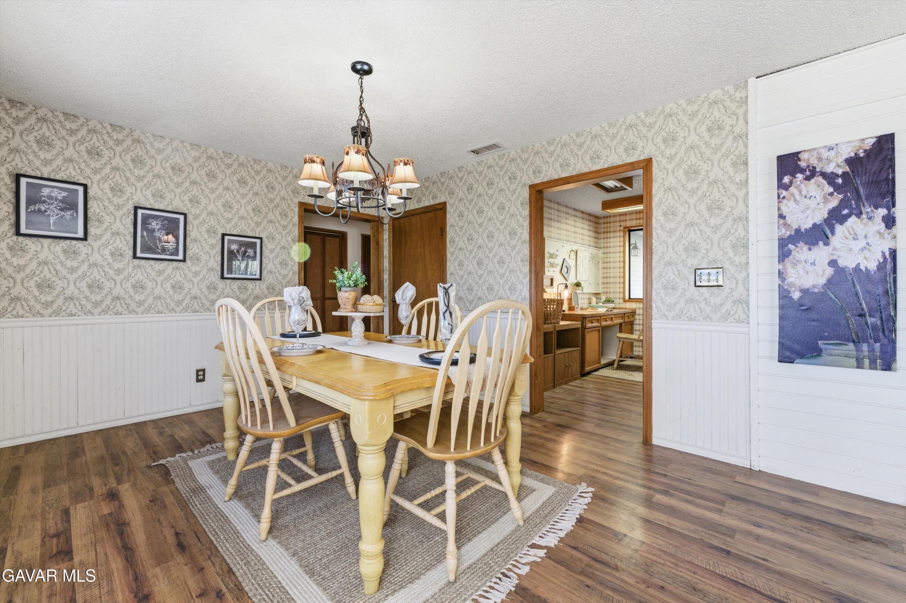 26181 Bear Valley Road Tehachapi, CA 93561 - Photo 21 of 38 a view of a dining room with furniture and wooden floor