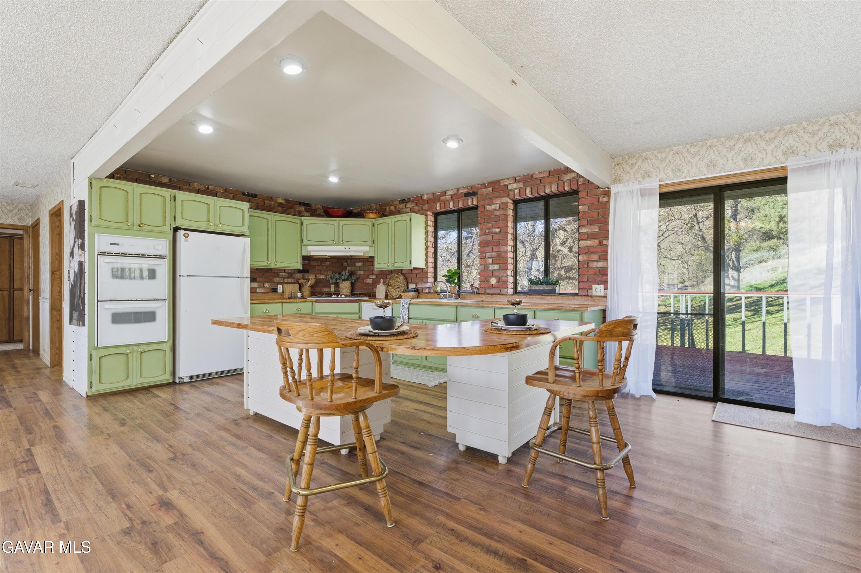 26181 Bear Valley Road Tehachapi, CA 93561 - Photo 22 of 38 a view of a dining room with furniture window and wooden floor