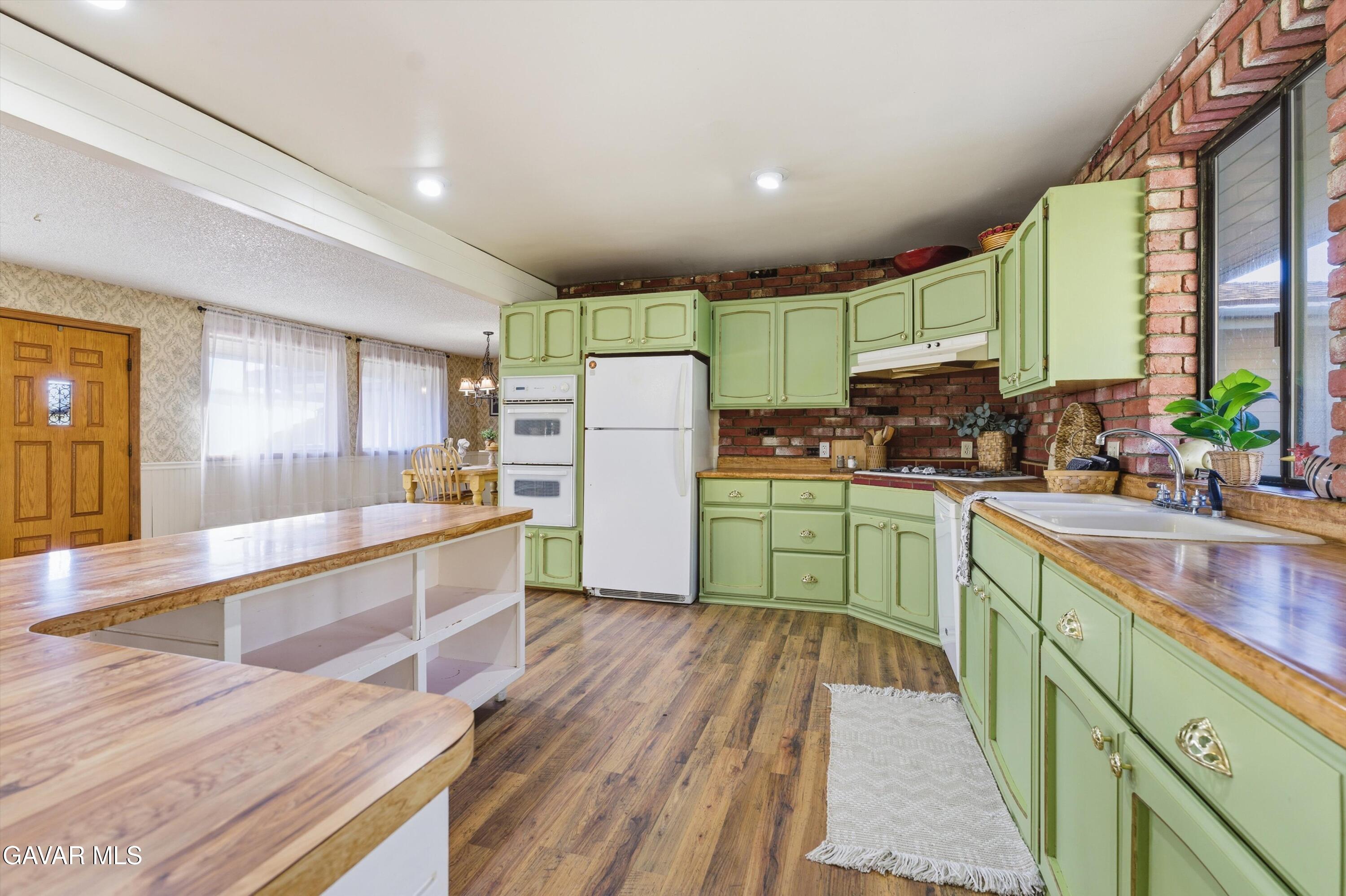 26181 Bear Valley Road Tehachapi, CA 93561 - Photo 24 of 38 a kitchen with a sink appliances cabinets and a large window