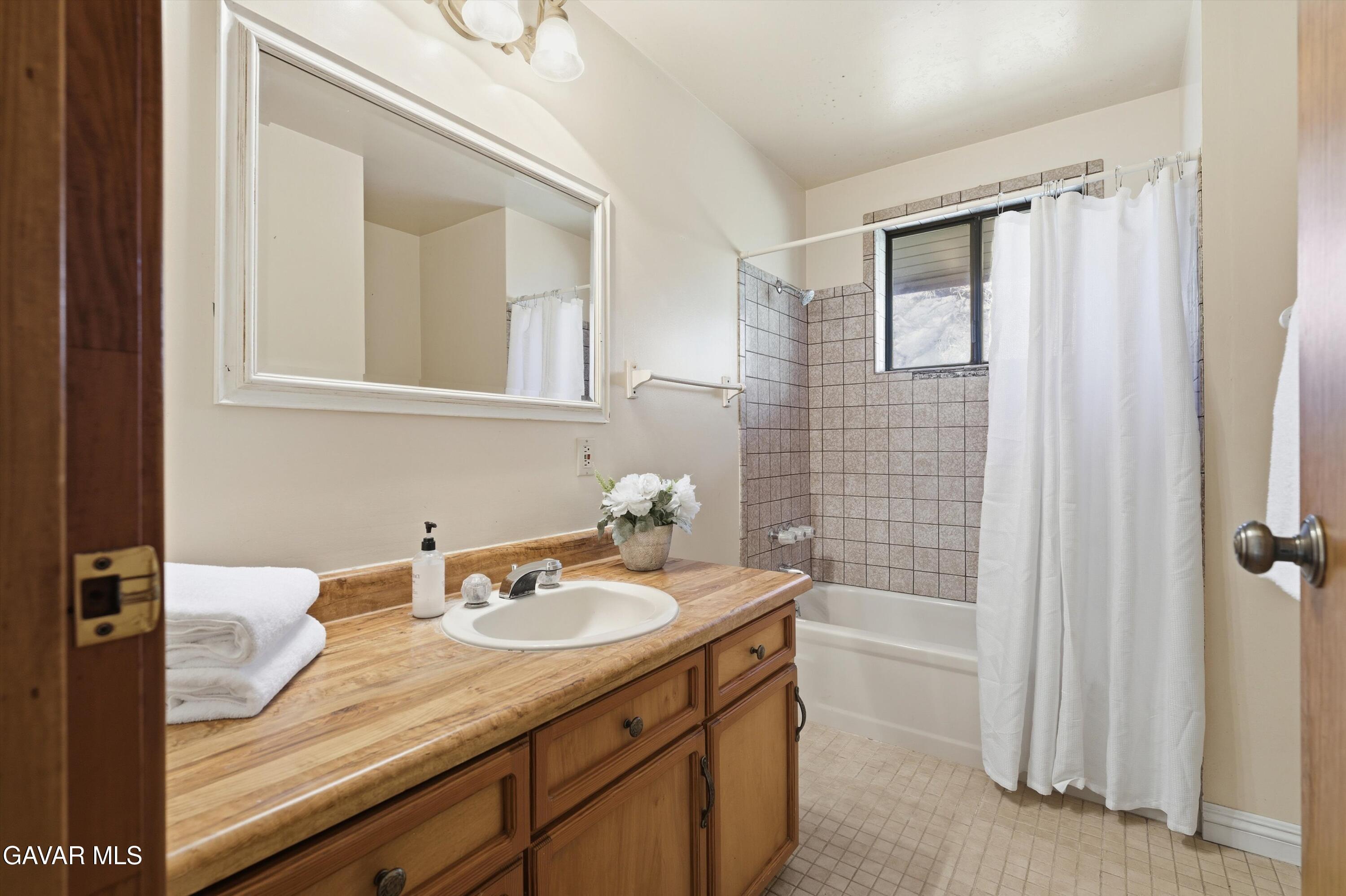 26181 Bear Valley Road Tehachapi, CA 93561 - Photo 28 of 38 a bathroom with a sink and a mirror