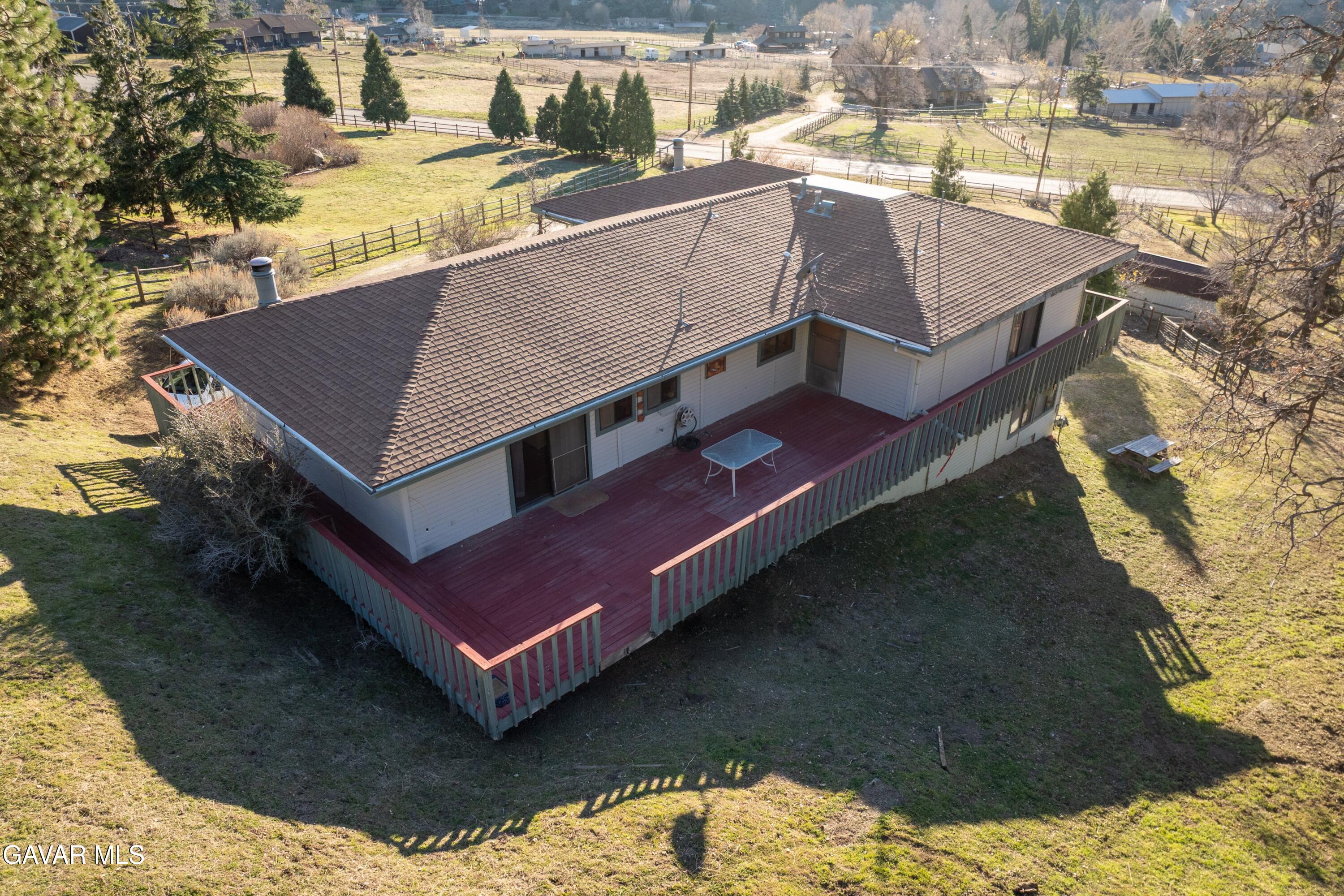 26181 Bear Valley Road Tehachapi, CA 93561 - Photo 28 of 38 a house with trees in the background