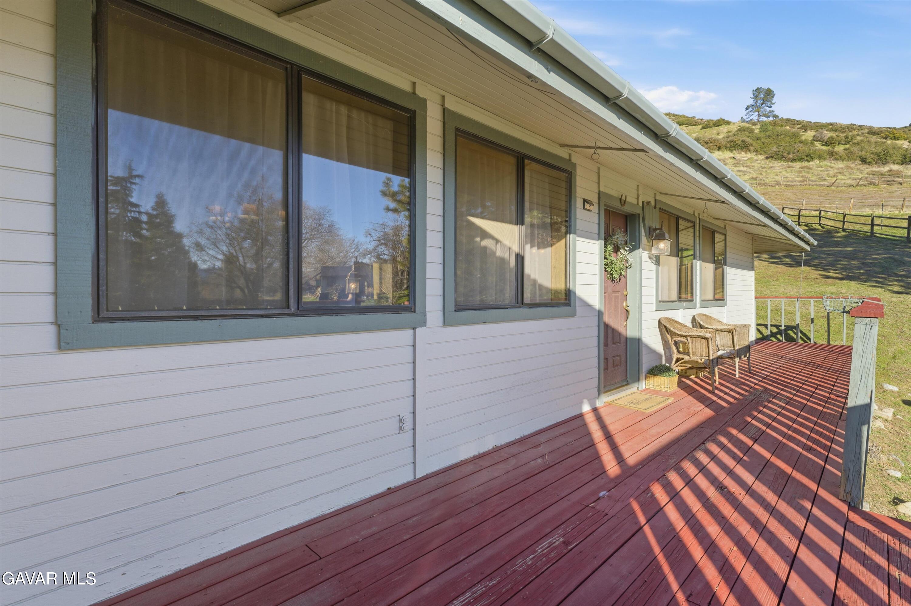 26181 Bear Valley Road Tehachapi, CA 93561 - Photo 3 of 38 a view of balcony with wooden floor
