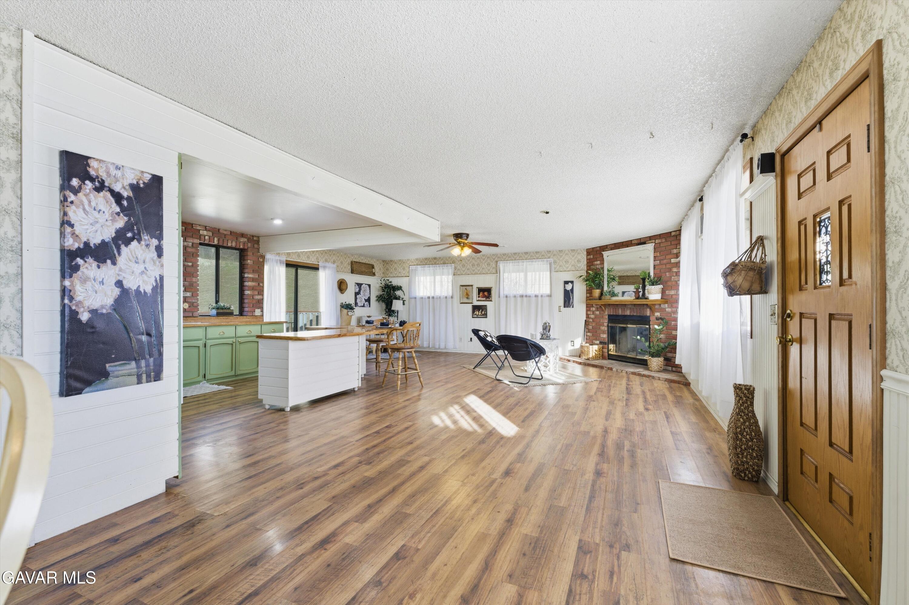 26181 Bear Valley Road Tehachapi, CA 93561 - Photo 5 of 38 a view of a living room kitchen and a wooden floor