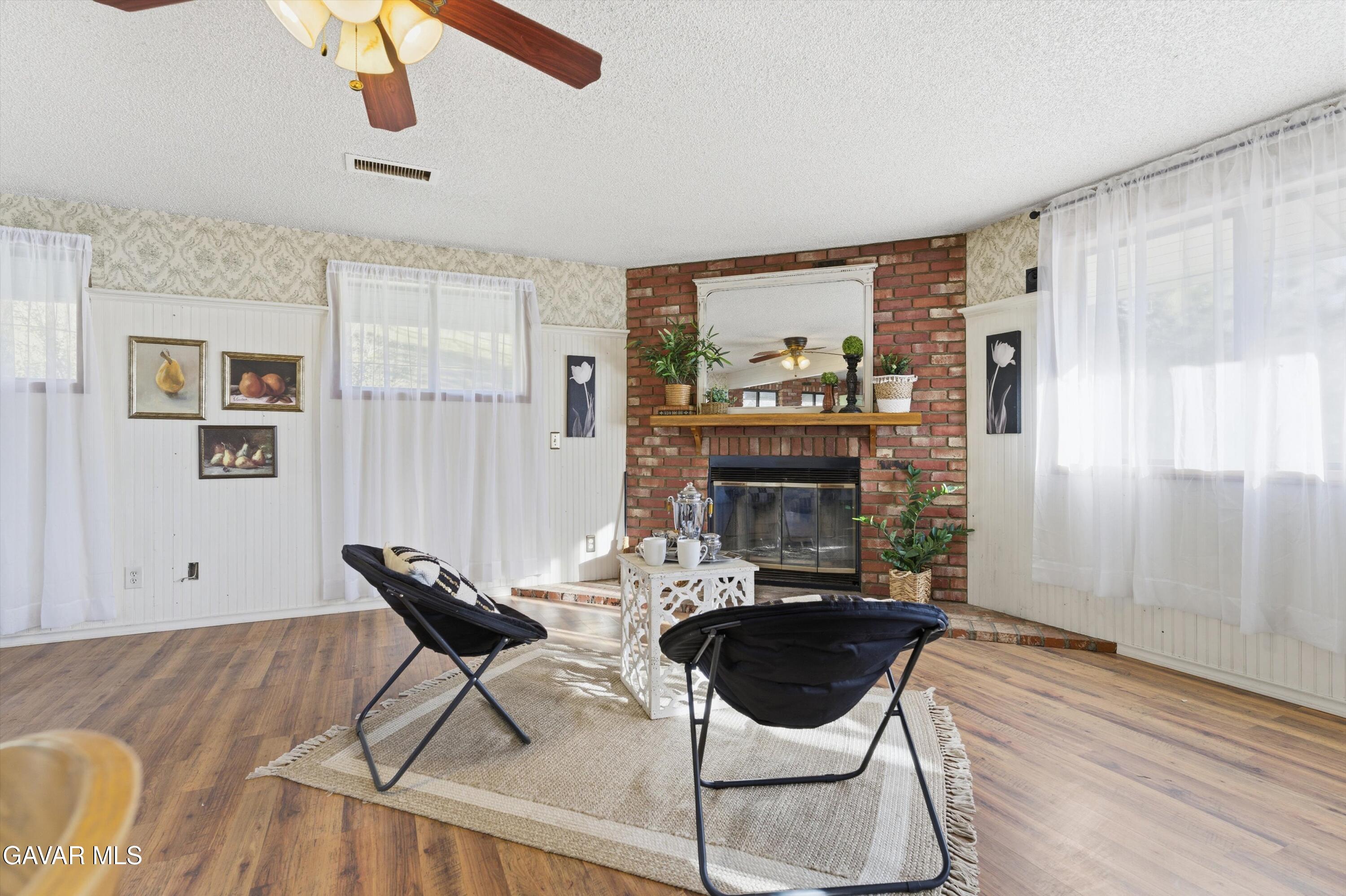 26181 Bear Valley Road Tehachapi, CA 93561 - Photo 6 of 38 a living room with furniture and a fireplace