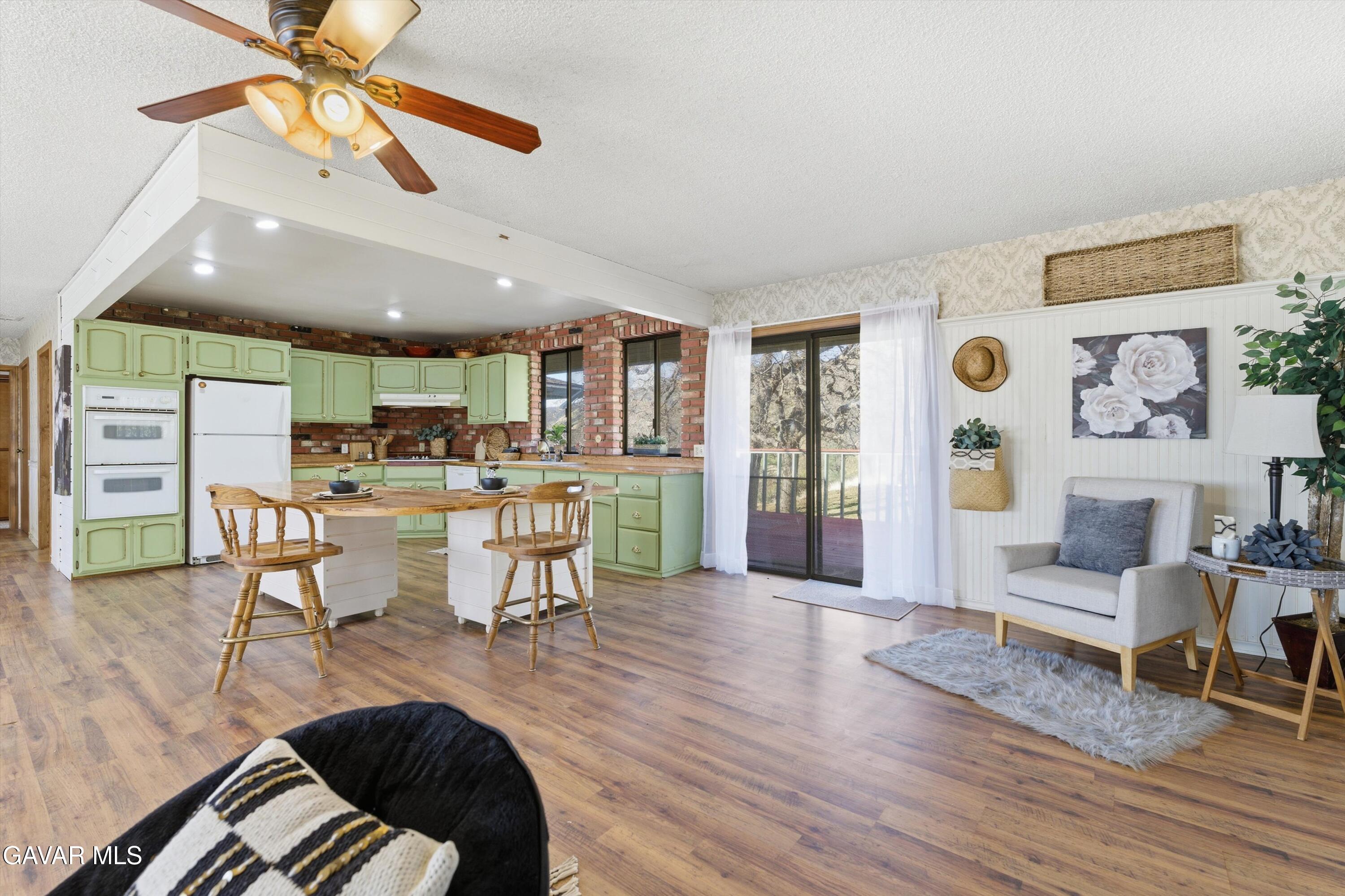 26181 Bear Valley Road Tehachapi, CA 93561 - Photo 7 of 38 a living room with furniture and wooden floor