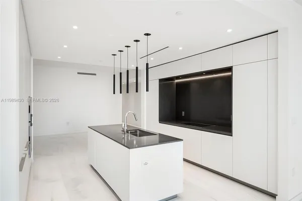 a kitchen with stainless steel appliances a microwave a sink and a refrigerator