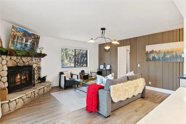 a living room with furniture fireplace and window