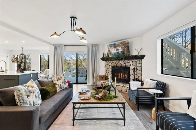 a living room with furniture a rug and a fireplace