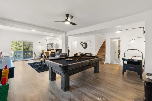 a living room with furniture wooden floor and a table