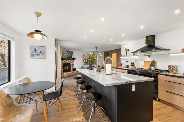 a room with stainless steel appliances kitchen island a table and chairs in it