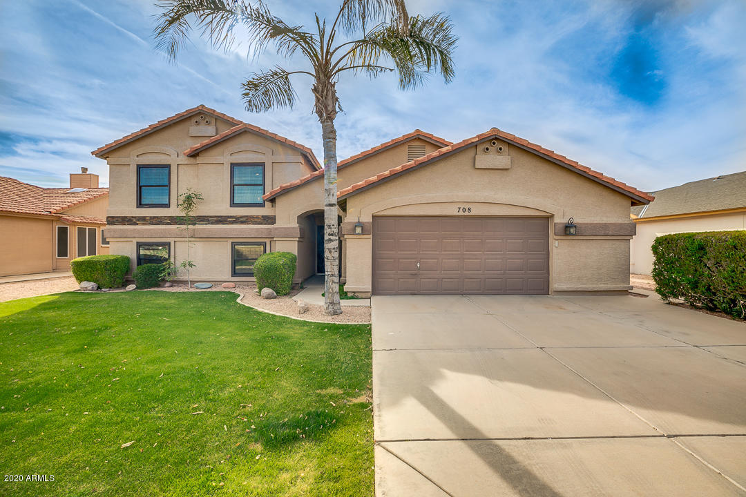 708 South Riata Street Gilbert, AZ 85296 - Photo 1 of 52 a front view of a house with a garden and yard