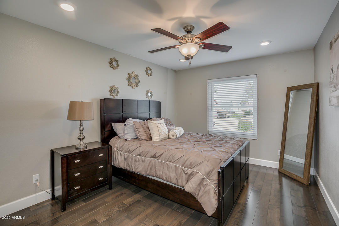 708 South Riata Street Gilbert, AZ 85296 - Photo 32 of 52 a bedroom with a bed and a chandelier