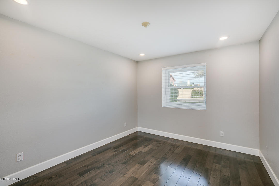 708 South Riata Street Gilbert, AZ 85296 - Photo 34 of 52 an empty room with wooden floor and windows