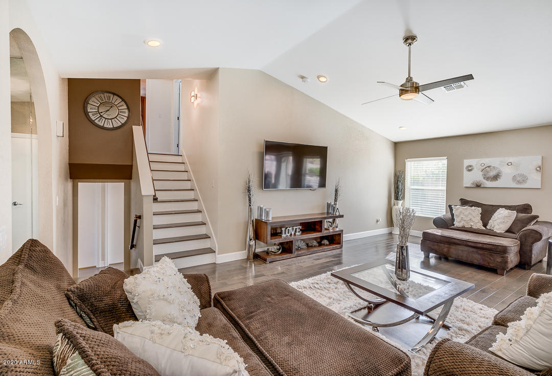 708 South Riata Street Gilbert, AZ 85296 - Photo 6 of 52 a living room with furniture and a wall painting