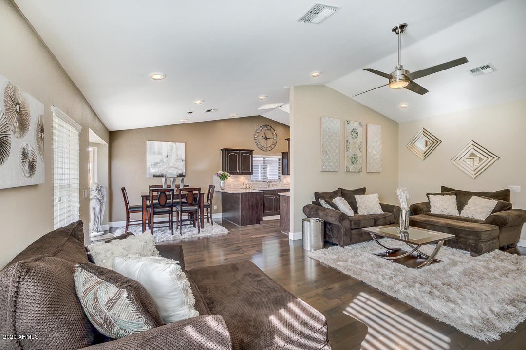 708 South Riata Street Gilbert, AZ 85296 - Photo 8 of 52 a living room with furniture kitchen view and a chandelier