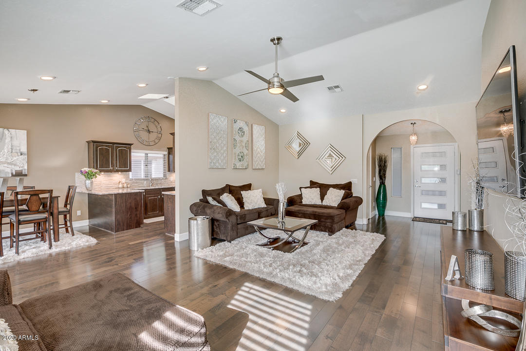708 South Riata Street Gilbert, AZ 85296 - Photo 9 of 52 a living room with fireplace furniture and a view of kitchen