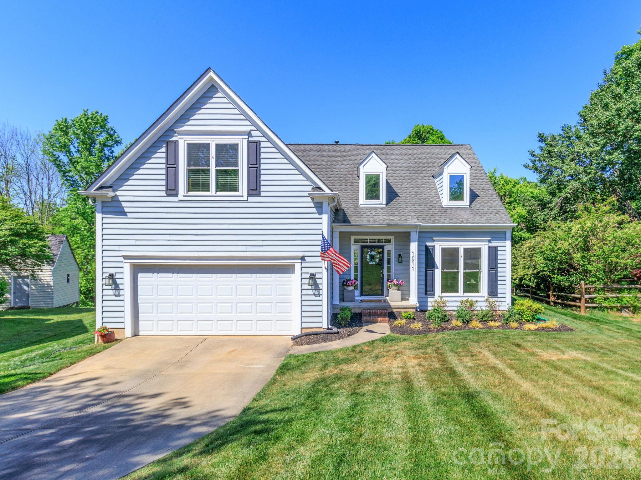 1011 Clearbrook Road Matthews, NC 28105 - Photo 1 of 46 a front view of a house with a yard and potted plants