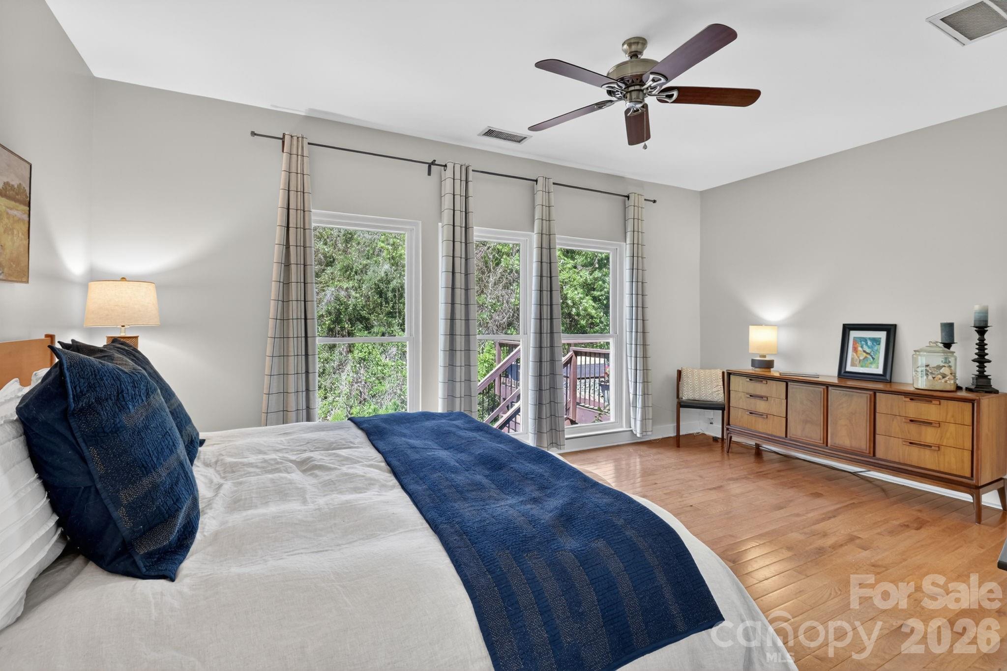 1011 Clearbrook Road Matthews, NC 28105 - Photo 18 of 46 a spacious bedroom with a bed and a chandelier