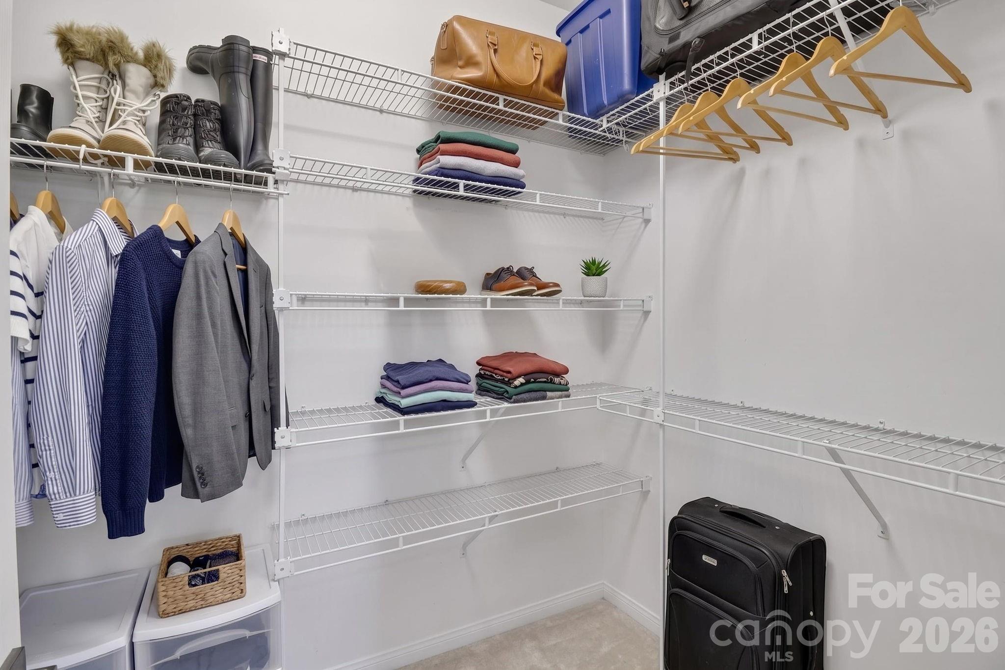 1011 Clearbrook Road Matthews, NC 28105 - Photo 21 of 46 a view of walk in closet with clothes and shoes