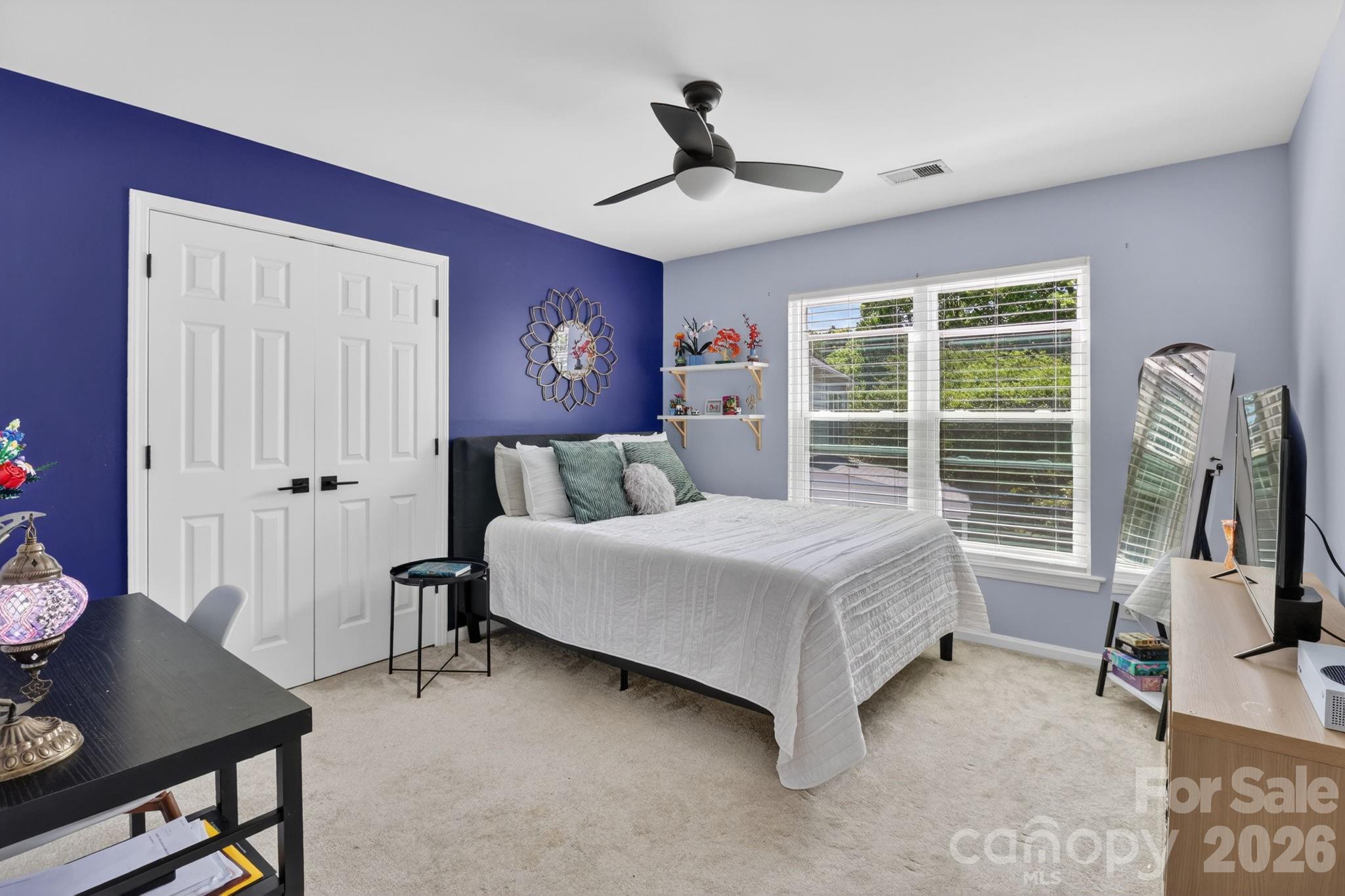 1011 Clearbrook Road Matthews, NC 28105 - Photo 27 of 46 a bedroom with a bed flat screen tv and a large window