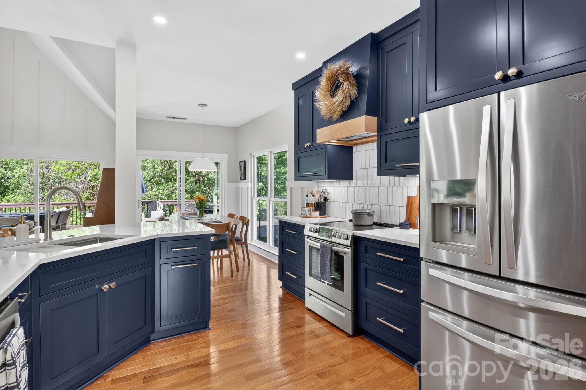 1011 Clearbrook Road Matthews, NC 28105 - Photo 6 of 46 a kitchen with stainless steel appliances a sink cabinets and wooden floor