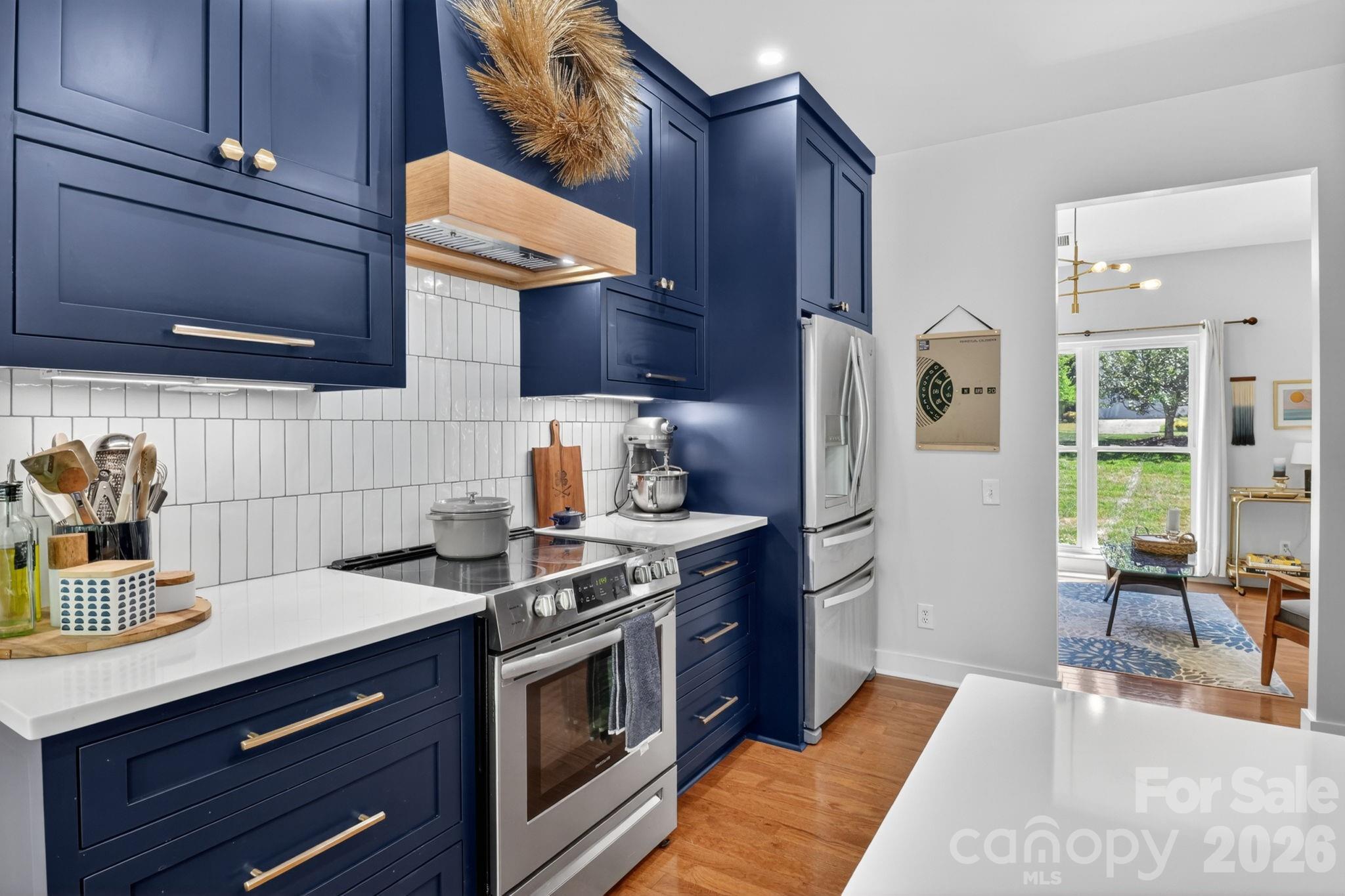 1011 Clearbrook Road Matthews, NC 28105 - Photo 9 of 46 a kitchen with stainless steel appliances granite countertop a stove a sink and a refrigerator