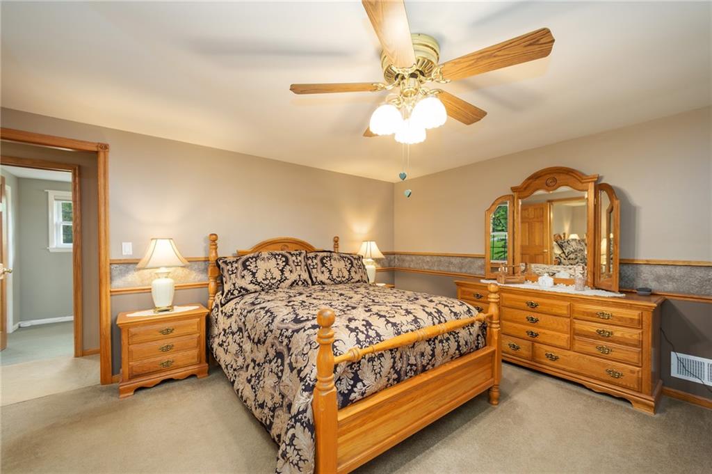 2387 Harrison City Road Export, PA 15632 - Photo 13 of 25 a bedroom with a bed and a chandelier
