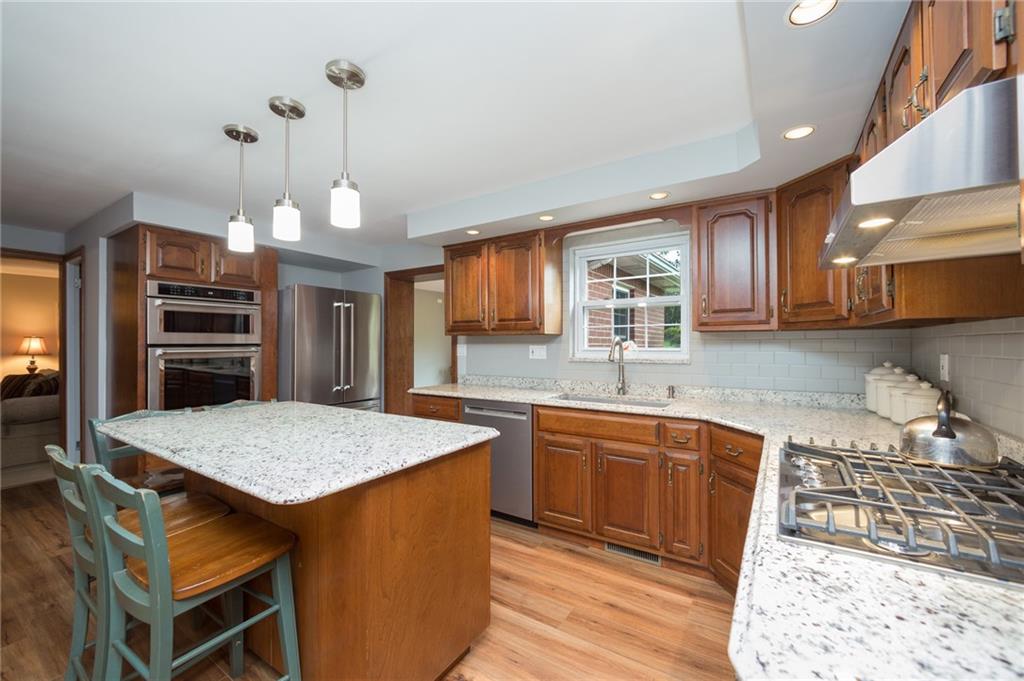 2387 Harrison City Road Export, PA 15632 - Photo 2 of 25 a kitchen with stainless steel appliances granite countertop a sink stove and refrigerator